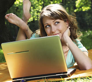 teen-girl-on-grass-with-computer