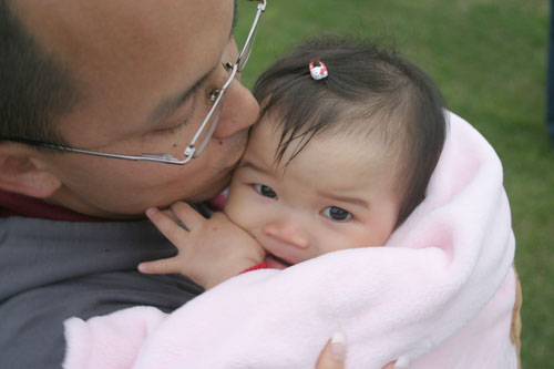 Asian-dad-kissing-infant-girl