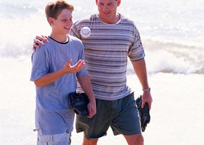 dad teen son beach baseball gloves