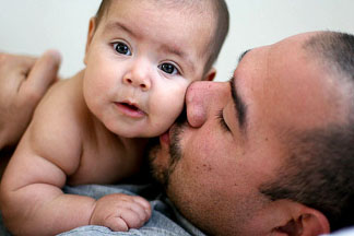dad-holding-infant-son-kiss-cheek