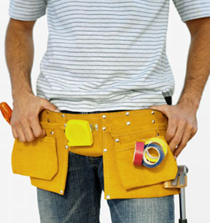 Mid section of a workman wearing a tool belt