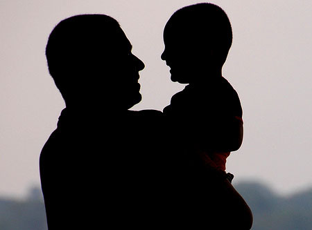 dad-holding-preschool-boy-silhouette