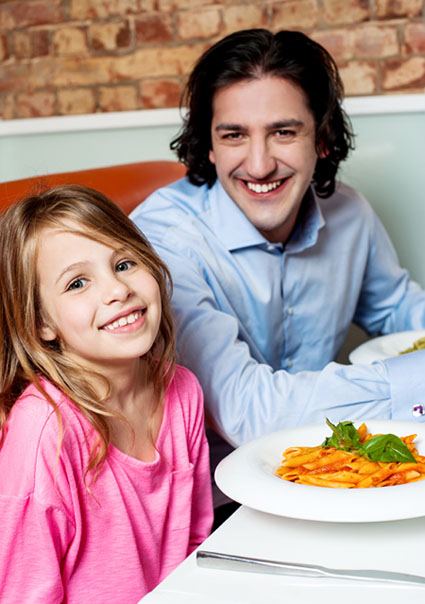 Little girl with her father in restaurant